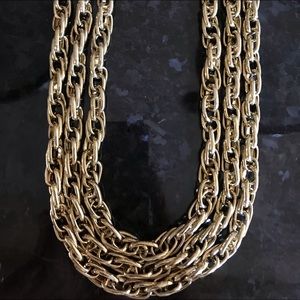 Triple strand goldtone necklace.